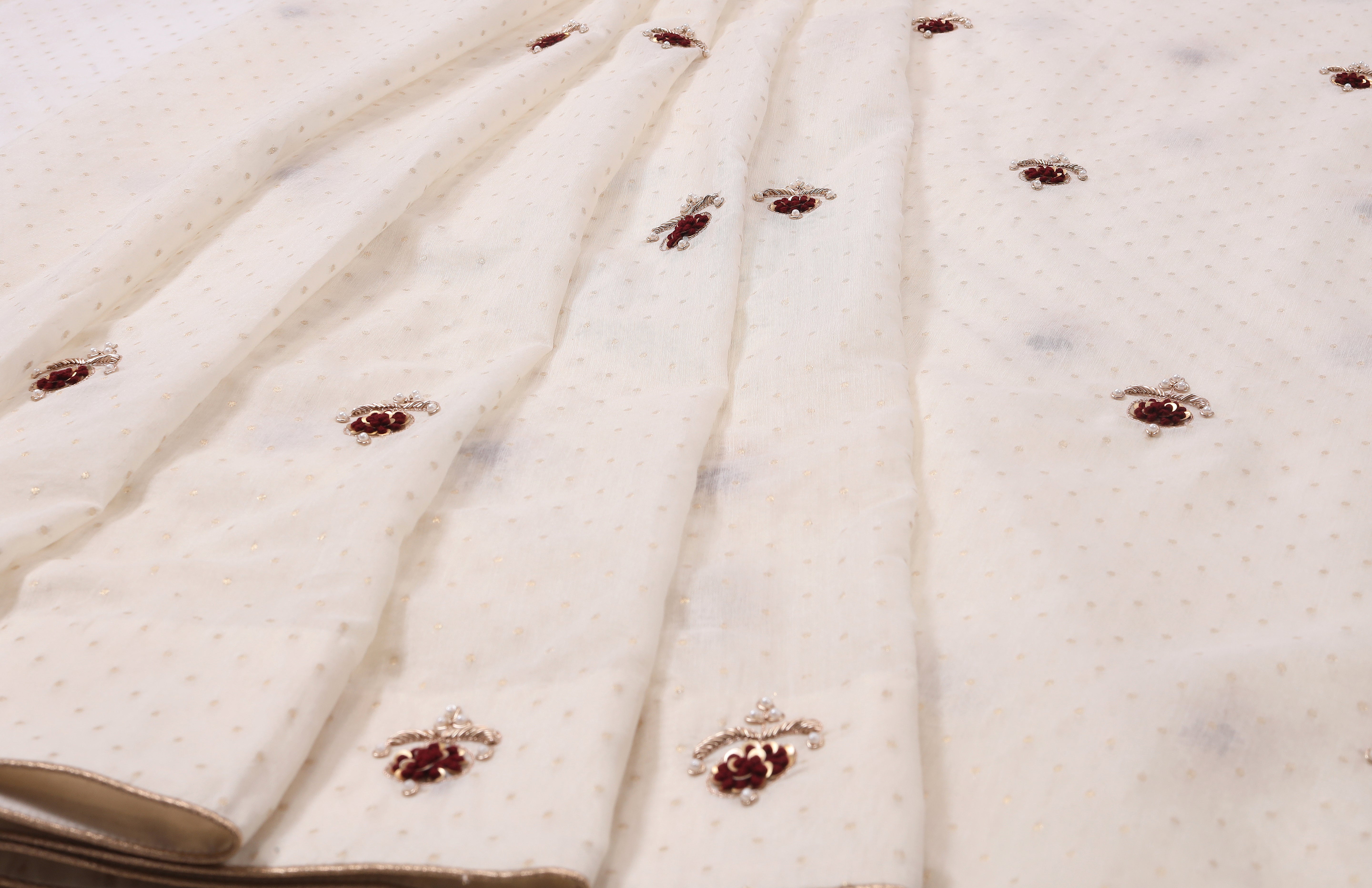 Off-White Cotton Saree with Maroon Embroidered Motifs & Subtle Gold Dot Texture