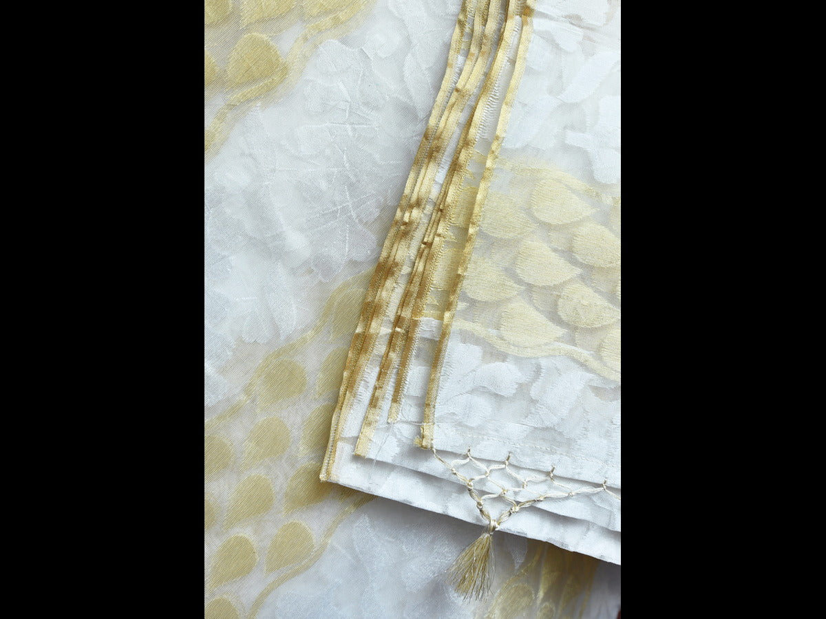 Off-white cotton saree featuring a subtle golden hue, adorned with black thread work and an abstract beaded design.